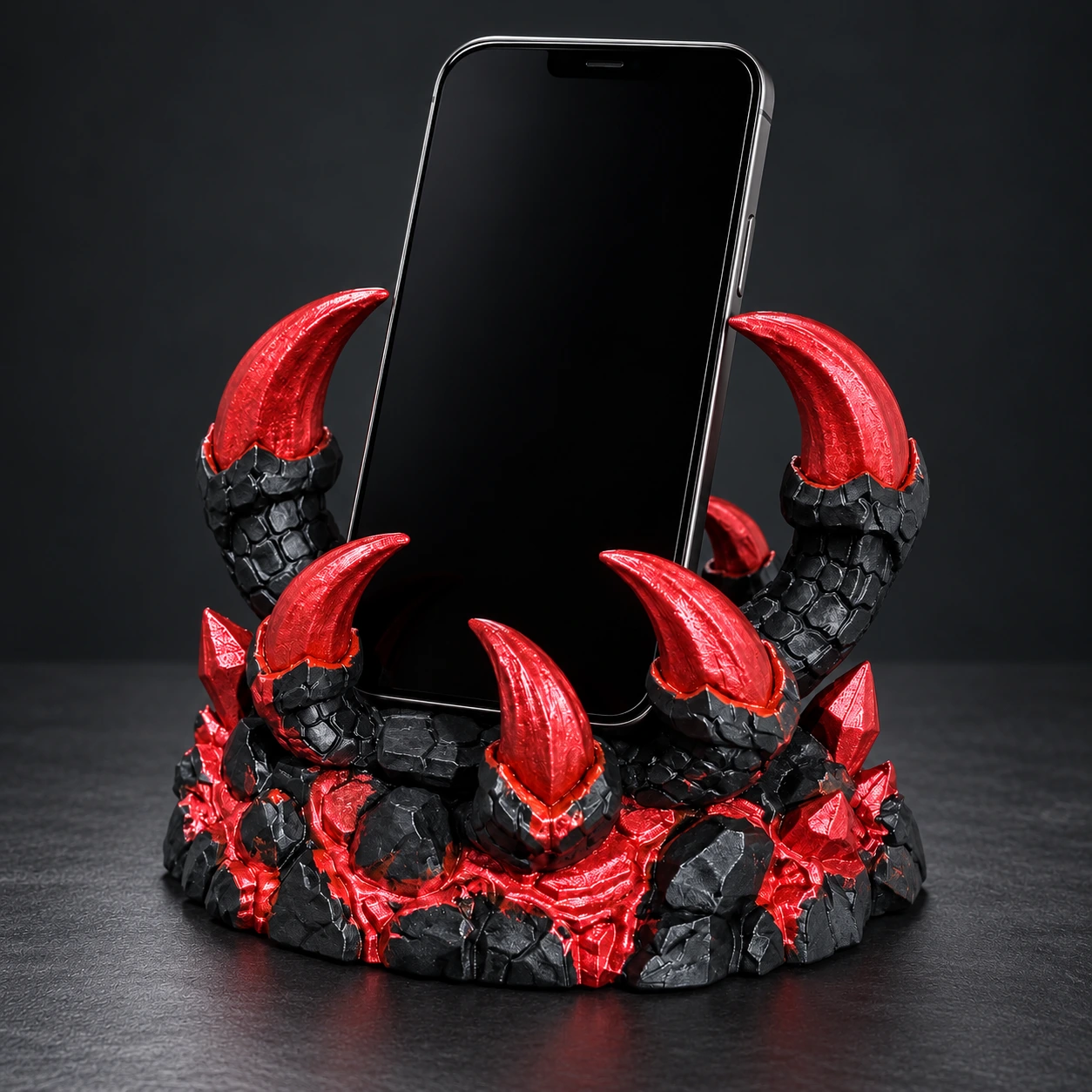 Black Draclaw dragon-claw phone stand with curved red talons and a rocky base